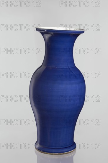 Vase, Chinese, decorative vessel, Qing style 1644–1911, 19th century, China; ceramic vessel; height 62.5 cm, diameter 28.5 cm., A tall, curving ceramic vase in deep blue with a glossy finish and a flared white rim, shown against a light gray background; the vase has a narrow neck, a rounded midsection, and a slightly flared base with a thin metallic-looking band at the bottom.