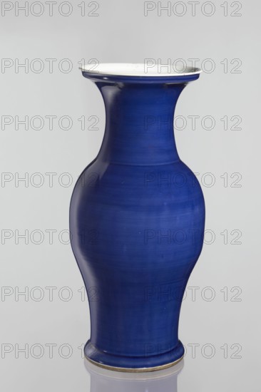 Vase, Chinese, decorative vessel, Qing dynasty 1644–1911, 19th century, ceramic vessel, height 62.5 cm, diameter 28.5 cm., A smooth ceramic vase with a curving silhouette in deep cobalt blue, featuring a flared rim with a white interior and a thin darker edge, a gently rounded body that tapers toward the base, and a small visible base band with a metallic or muted gold tone; the background is a neutral pale gray.