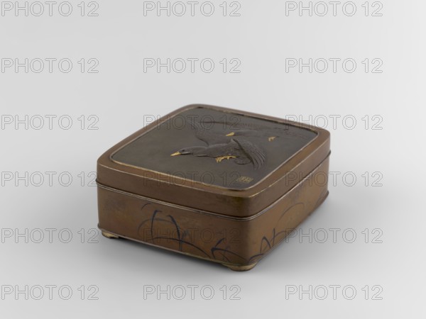 Box with a lid, Jômi, Eisuke I 1839-1899 author. Rectangular box with rounded corners, decorated on the flat lid with two flying wild geese made in high relief with inlay of silver and gold iro-e zogan technique. The side walls are decorated with a motif of inclined reeds, made of silver and shakudo using the hira-zogan technique, so the decorative motif is level with the background surface, giving a painted effect. On the lid there is a signature made in gold: in a square field, two stylized kanji characters resembling archaic ones: Shobi. ca. 1880–1899 Meiji Period, 1868–1912, Kyoto, Japan. Container. Height 4.8 cm; width 10.2 cm; depth 11.4 cm., A rectangular metal box with rounded corners sits on a neutral light gray surface; the box is mainly brown with darker brown and black areas, and small accents of gold on a relief of birds on the lid. The lid features a raised design of a group of birds in flight with textured wings and gold-tipped beaks and feet, and the sides of the box sh...