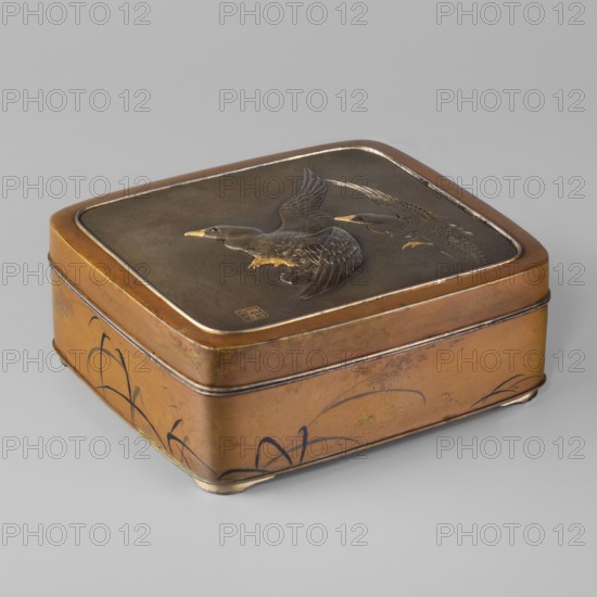 Box with a lid, Jômi, Eisuke I 1839-1899 artist, geese, grass, Japanese art, boxes, Japanese culture, Meiji 1868-1912, lids. Rectangular box with rounded corners, decorated on the flat lid with two flying wild geese, made in high relief with inlay of silver and gold iro-e zogan technique. The side walls are decorated with a motif of inclined reeds, made of silver and shakudo using the hira-zogan technique, i.e. the decorative motif is level with the background surface, giving a painted effect. On the lid there is a signature made in gold: in a square field, two stylized kanji characters resembling archaic ones: Shobi. Ca. 1880–1899 Meiji Period, 1868–1912, Japan, Kyoto. Container; height 4.8 cm, width 10.2 cm, depth 11.4 cm., A square metal box with rounded corners sits on a gray surface, showing a warm brown and bronze exterior with darker brown top inset; the lid features a raised depiction of a flying bird rendered in dark brown with golden accents on the beak and feet, and a second...