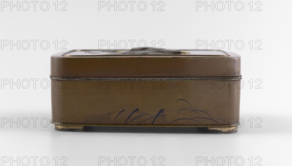 Box with a lid, Jômi, Eisuke I 1839–1899 artist; rectangular box with rounded corners; decorated on the flat lid with two flying wild geese in high relief with inlay of silver and gold iro-e zogan technique; side walls decorated with a motif of inclined reeds in silver and shakudo using the hira-zogan technique, producing a painted effect; gold signature on the lid in a square field with two stylized kanji characters resembling archaic forms: Shobi; ca. 1880–1899 Meiji period, 1868–1912, Kyoto, Japan; container; height 4.8 cm, width 10.2 cm, depth 11.4 cm., A rectangular metal box with a hinged lid shown from the front, finished in brown with a few darker brown and black decorative strokes along the lower front panel, sitting on small rounded feet with areas of worn gold color, and a thin darker metal band where the lid meets the base; the background and surface are white and light gray.