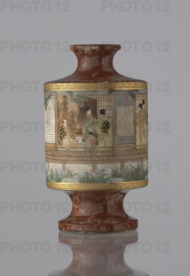 Vase, Kinkôzan, Sôbei VII 1867–1927 maker, Kinkôzan workshop; gift, repossession Kraków. Genre scenes; Japanese art; ceramics; vases; motifs: wisterias, irises, bamboos. Meiji 1868–1912. Vase in the shape of a sake bottle, on a stem. Short, narrow neck. 19th/20th century Meiji period, Japan, Kyoto. Vessel; height 11.7 cm; diameter 6.5 cm., A cylindrical decorative vessel with a flared neck and foot, both in a mottled reddish-brown with lighter veining, has a central band decorated with a painted scene and framed by narrow gold borders with geometric patterns; the painted scene shows a group of people wearing patterned robes in a pavilion setting with wooden railings, screens, and hanging foliage, and a small child near the seated figures, while the lower edge of the scene includes a waterside area with green and purple plants and grasses; overall colors visible include reddish-brown, gold, green, purple, black, cream, and pale blue-gray.