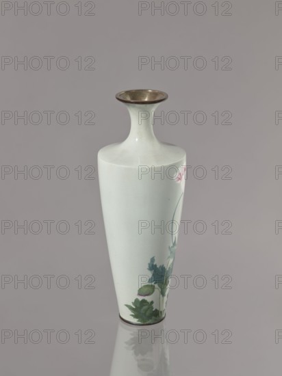 Vase, cloisonné enamel; symmetrical decoration of blooming poppies on a grey-blue background; flowers poppies iconography; Meiji–Taisho period, ca. 1910–1920; Nagoya, Japan; vessel; height 24.5 cm, diameter 9.0 cm., A pale celadon vase with a narrow neck flaring to a wide metallic-rimmed mouth stands against a muted gray background, showing a smooth glossy surface and a hand-painted botanical motif in shades of green and pink near its lower half, with darker green leaves and a bud, and a subtle reflection of the vase visible on the surface below.