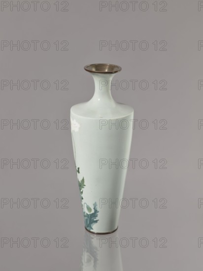 Vase, poppies, Japanese art, Japanese culture, flowers iconography, Meiji 1868–1912 / Taisho 1912–1926, cloisonné enamel, ca. 1910–1920, Nagoya, Japan; vessel, height 24.5 cm, diameter 9.0 cm., A pale blue-green tall vase with a narrow neck flaring to a metallic rim, a tapered cylindrical body with a few painted green leaves and pale flowers near the lower side, a metallic band at the base, set against a smooth gray background and reflected faintly on the surface below.