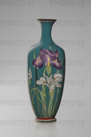 Vase, Ovoid vase one of a pair, slender, on a low ring-shaped foot and a narrow neck, flaring at the rim. The foot and mouth are framed with sheet metal. Decorated with a motif of a blooming iris bush, captured with naturalistic fidelity and attention to a variety of color tones. Executed using the yusen cloisonné enamel technique, the motif is placed against a uniform sea-green background. Around the foot and the rim there are narrow, colorful borders, also made using the yusen technique, composed of small triangular forms called cicada wings. Japanese, Nagoya; ca. 1900 Meiji period, 1868–1912. Vessel; height 25 cm, width 9.7 cm, depth 8.8 cm., A tall, narrow-necked vase with a glossy teal surface decorated with a floral design; the painted flowers include large purple blooms with yellow accents and several white blooms with subtle gray shading, all set among long green leaves and stems in varying shades of green; the vase has a brown rim and a decorative band of red and patterned col...