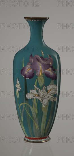 Vase, ovoid one of a pair, slender on a low ring-shaped foot with a narrow neck flaring at the rim; foot and mouth framed with sheet metal. Decorated with a motif of a blooming iris bush, rendered naturalistically with varied color tones, executed using the yusen cloisonné enamel technique against a uniform sea-green background. Narrow, colorful yusen borders of small triangular cicada wing forms around the foot and rim. Japanese, Nagoya; Meiji period, ca. 1900. Vessel. Height 25 cm; width 9.7 cm; depth 8.8 cm., A tall vase with a narrow neck and flared rim sits against a neutral background, the vase surface primarily teal with decorative bands of brown and red near the top and base; a group of large purple flowers with yellow accents and several white flowers with subtle gray shading are painted on the body, accompanied by long green leaves and stems in varying shades of green.