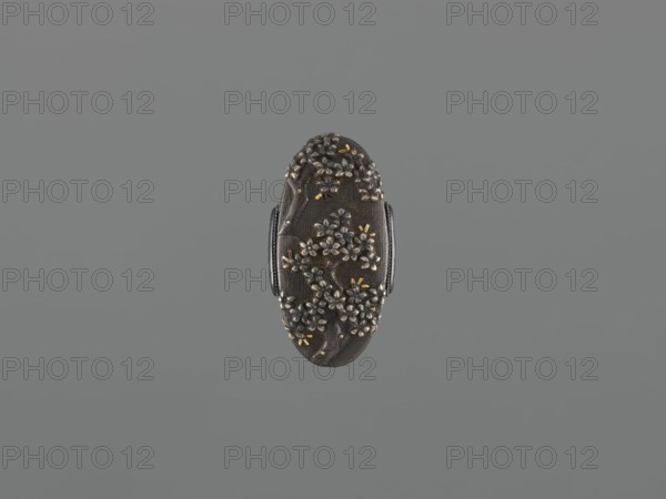 Sword hilt cap kashira, ; decorated with flowers and twigs, grained background, gold and silver inlaid decoration; kashira for katana/saber; Japanese, Edo period 18th century, 1603–1868; height 3.6 cm, width 2.0 cm, depth 0.8 cm., An oval dark brown object with a textured surface and a raised floral design covering much of its face, the flowers appearing in metallic silver with small accents of metallic gold, flanked on either side by darker brown ridged handles, all set against a uniform medium gray background.
