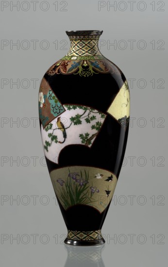 Vase by Namikawa Yasuyuki 1845–1927, ca. 1890–1905 Meiji period. Small, slender cloisonné enamel vase, height 18.0 cm, diameter 7.8 cm. Body tapers toward the bottom and terminates in a ring-shaped silver foot; arms merge into a short neck slightly parted at the spout, enclosed by a silver ring. Ornamental shippo cloisonné border with rosettes in rhomboid fields at the foot and a similar ornament on the neck. Petal decoration filled with stylized phoenix images flows down to the shoulders. Belly covered with shiny black enamel decorated with six colorful fan-shaped reserves bearing various floral and bird motifs, executed with meticulous precision in the yusen technique with silver wires. Silver plaque mounted in the mirror of the bottom engraved: Kyoto Namikawa. Origin: Kyoto, Japan., A tall, glossy vase with a primarily black background features decorative panels in muted colors including cream, pale yellow, brown, green, turquoise, purple, and gold; the neck and foot have a patterne...