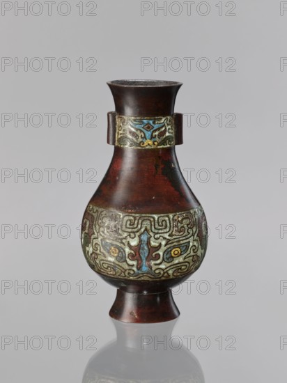 Vase, Chinese, taotie iconography, Qing dynasty 1644–1911, 19th century, ceremonial/ritual vessel, bronze vessel, height 24 cm, diameter 13.1 cm, A single vase with a flared rim and a rounded body tapering to a narrow foot is shown against a plain light gray background, the vase surface appearing mostly dark brown with reddish tones and areas of lighter wear, a decorative band around the neck and a wider ornate band around the bulbous midsection feature intricate swirling patterns in shades of pale green, blue, yellow, and muted gold, the decorative motifs including symmetrical curving shapes and small circular elements, the vase has a glossy finish with subtle reflections and a soft shadow and faint reflection visible on the surface beneath it.