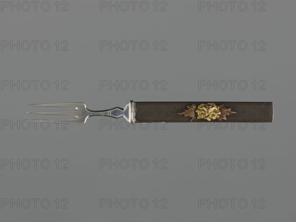 Fork with knife handle kozuka, Japanese, Edo period 1603–1868, 18th century. Melee weapon accessory for sword katana — kozuka. Plastic decoration: chrysanthemum flower with two leaves, textured background. Materials: cutlery. Dimensions: height 16.6 cm, width 1.4 cm, depth 0.8 cm., A three-pronged metal fork with a silver-toned tine section and a dark rectangular handle that features a raised floral decoration in gold and bronze tones; the tines are slender and pointed, the metal transition to the handle includes a short decorative collar in silver, and the handle surface appears textured in dark brown with a central floral motif showing gold petals and bronze leaves against a solid muted gray background with shades of gray.