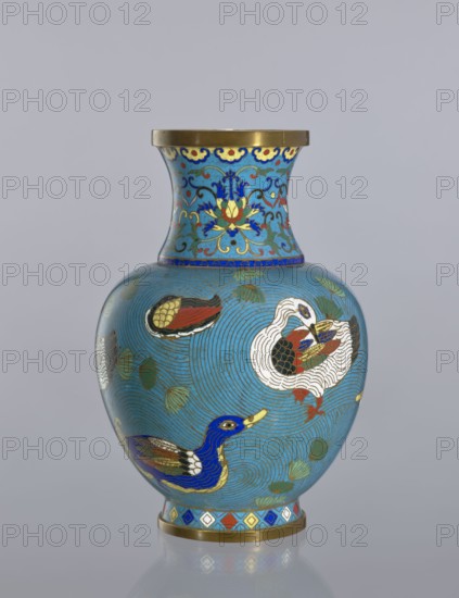 Vase, gift, Paderewski, Ignacy Jan 1860-1941, Chinese art, Chinese, Qing 1644–1911, decorative vessel, ducks, lotus tendril ornament, cloisonné enamel. Vase on a foot with a neck; decoration: ducks on a turquoise background, lotus tendril on the neck. 19th century, China. Height 23.5 cm, A rounded vase with a flared neck, mainly turquoise blue, decorated with a few stylized birds in colors including blue, white, gold, red, black, and green, with swirling circular line patterns across the body and scattered green leaf shapes; the neck area features ornate floral and scroll motifs in blue, yellow, red, and gold, and both the rim and the base have gold bands with a decorative geometric band of blue, red, white, and gold above the base.