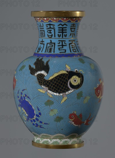 Vase, Gift; Paderewski, Ignacy Jan 1860–1941. Chinese, Qing dynasty 1644–1911. Cloisonné enamel vase on a foot with a neck. Decoration: fish and crabs on a turquoise background, archaizing inscription on the neck. 19th century, China. Vessel. Height 23.2 cm; diameter 9.1 cm., A rounded vase with a narrow neck and flared rim sits against a neutral gray background, predominantly turquoise blue with swirling wave patterns in darker blue lines; the body features a large black fish with gold-edged scales and yellow fins, several smaller red fish with white and gold accents, and a bright blue crab with gold highlights, along with green lotus leaves scattered among the wave motifs; the neck has a band of vertical dark motifs on the blue ground and a decorative red and gold border under the rim, while the base and rim are finished with metallic gold bands and a green-and-white wave-pattern border above the lower gold band.