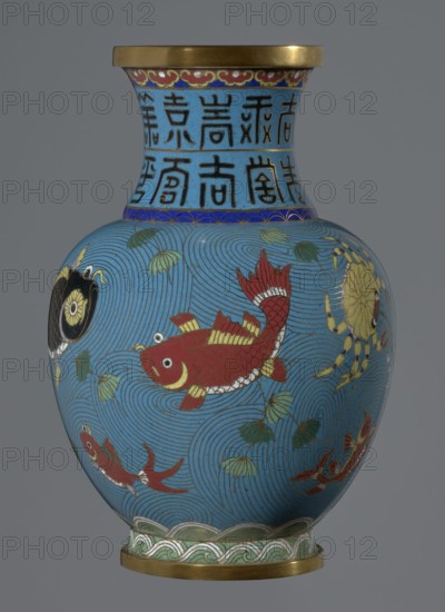 Vase;, Cloisonné enamel, 19th century China Qing dynasty. Vessel on a foot with a neck, height 23.2 cm, diameter 9.1 cm. Decoration: fish and crabs on a turquoise background, archaizing inscription on the neck. Chinese art; Qing style., A rounded vase with a flared rim and a narrow neck, decorated in bright enamel colors on a blue background; the body shows a large red fish with gold and white detailing, a few smaller red fish, a yellow crab, and a black and gold circular motif set against swirling blue wave patterns and scattered green leaves, the neck is banded with blue and gold decorative borders and vertical dark motifs, and both the rim and base have gold-colored metal fittings with a green and white wave-like border above the base.