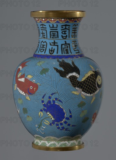 Vase, 19th century, China. Cloisonné enamel vessel on a foot with a neck. Decoration: fish and crabs on a turquoise background; archaizing inscription on the neck. Qing dynasty style. Height 23.2 cm; diameter 9.1 cm. Chinese art., A rounded decorative vase with a flared neck and metallic rim, predominantly turquoise blue with swirling wave patterns; the body features a group of colorful aquatic creatures including a red fish, a black fish with gold-scaled details, and a blue crab with gold accents, along with green aquatic plants; the neck has bands of darker blue and gold decorative motifs; the base shows a green and white wave-like border above a metallic foot; visible colors include turquoise blue, red, black, blue, green, gold, white, and metallic brass.
