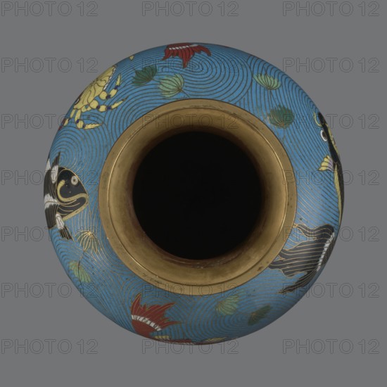 Vase. Chinese, Qing dynasty 1644–1911, 19th century. Cloisonné enamel on metal; vase on a foot with a neck. Decoration: fish and crabs on a turquoise background; archaizing inscription on the neck. Height 23.2 cm; diameter 9.1 cm., A round vessel shown from above with a dark central opening and a metallic gold rim, the body decorated with a bright blue background featuring swirling wave patterns, a group of stylized fish in black and gold with white accents, a few lotus-like leaves in green, and a few floral shapes in red and gold against a neutral gray backdrop.