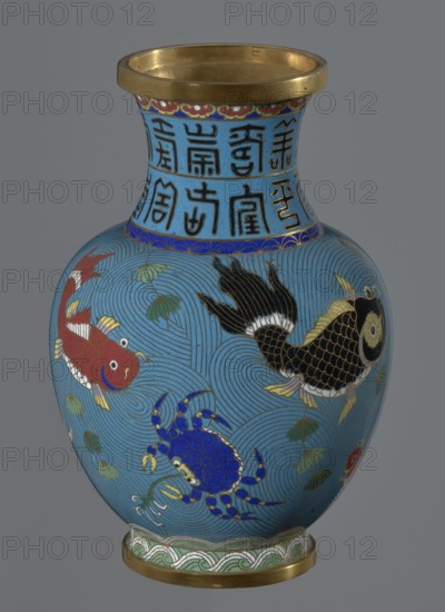 Vase, Chinese, Qing dynasty 1644–1911, 19th century. Cloisonné enamel vessel on a foot with a neck; decoration of fish and crabs on a turquoise background and an archaizing inscription on the neck. Height 23.2 cm; diameter 9.1 cm., A rounded vase with a flared rim and foot, primarily turquoise blue, decorated with a repeating wave pattern in darker blue lines; the rim and foot have gold-colored metal bands and the neck displays a band of geometric motifs in darker blue with accents of red and gold. The body shows colorful marine creatures including a red fish with white and yellow fins, a black and gold fish with white highlights, and a blue crab with yellow-tipped claws, along with green and yellow aquatic plants scattered among the wave motifs. The palette includes turquoise blue, dark blue, red, black, gold, yellow, white, and green.