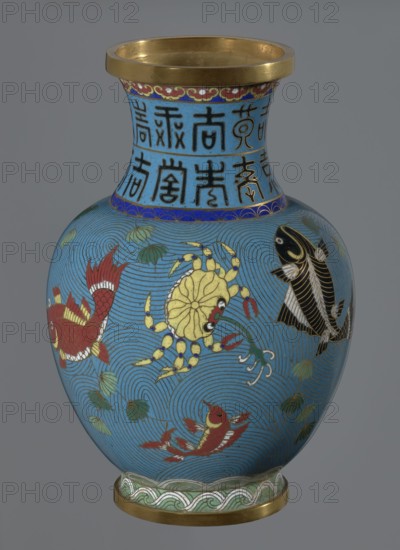 Vase, gift; Chinese; Qing dynasty 1644–1911; cloisonné enamel; vase on a foot with a neck; decoration: fish and crabs on a turquoise background, archaizing inscription on the neck; 19th century; China; vessel; height 23.2 cm, diameter 9.1 cm., A blue vase with a gold rim and gold base, decorated with a group of stylized aquatic creatures including a yellow crab, several red fish, and a black fish, set against concentric wave patterns and small green leaf-like motifs, with a band of blue near the neck containing dark vertical decorative marks and a narrow decorative border in red and gold below the rim.