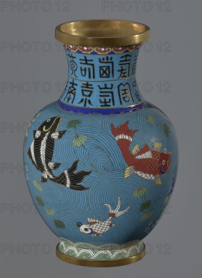 Vase, Chinese, Qing dynasty 1644–1911, 19th century. Cloisonné enamel on metal; vase on a foot with a neck. Decoration: fish and crabs on a turquoise background, archaizing inscription on the neck. Height 23.2 cm; diameter 9.1 cm., A rounded vase with a flared rim and a narrow neck, decorated on a bright blue background with swirling wave patterns and a few stylized green leaves; the neck has a band of dark blue and a section with dark linear characters on the blue ground that are not described, and a thin decorative border beneath the rim in red, gold, and white; the body shows a group of fish in different colors—a red fish with gold and white fins, a black fish with white accents, and a white fish with red and blue details—outlined in gold and surrounded by concentric circular wave motifs; the base and rim edges have gold-colored metal bands and the foot has a green and white wave-patterned band.