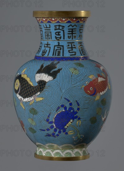 Vase, Chinese, Qing dynasty 1644–1911, 19th century. Cloisonné enamel on vessel on a foot with a neck. Decoration: fish and crabs on a turquoise background, archaizing inscription on the neck. Height 23.5 cm; diameter 9.3 cm., A rounded vase with a flared neck, primarily colored bright blue with darker blue concentric wave patterns across its body, features decorative bands near the top and base in gold and green tones. The neck area has a lighter blue background with black linear motifs; a narrow band of deep blue with gold accents separates the neck from the body. The body displays a group of colorful aquatic creatures: a black and gold fish with white and yellow fins, a red and gold fish with white accents, and a vivid blue crab with gold and white detailing. There are also several green leafy elements and small white accents scattered among the wave patterns. The rim and base edges are metallic gold, and the lowest decorative band includes green and white wave-like motifs. The over...