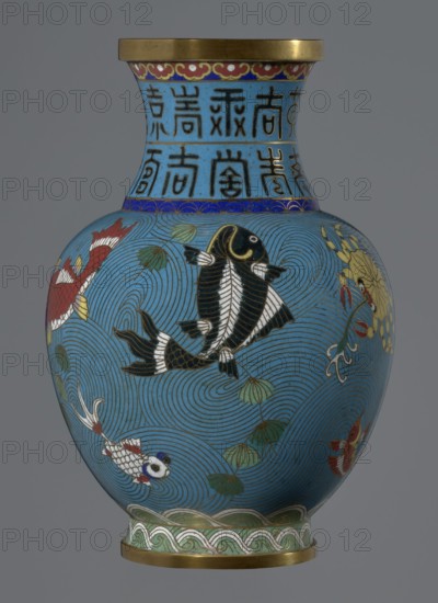Vase, Gift; Paderewski, Ignacy Jan 1860–1941. Chinese, Qing dynasty 1644–1911. Cloisonné enamel vase on a foot with a neck. Decoration: fish and crabs on a turquoise background, archaizing inscription on the neck. 19th century, China. Vessel; height 23.5 cm, diameter 9.3 cm., A rounded vase with a flared neck and gold rim, primarily turquoise blue with swirling wave patterns, decorated with several stylized fish in black, red, white, and gold, along with green lotus leaves and stems; the neck features a band of repeated vertical block-like motifs in dark blue on a lighter blue background and a narrow decorative border in red, gold, and blue beneath the rim, while the foot has a green and white wave-like pattern above a thin gold base.