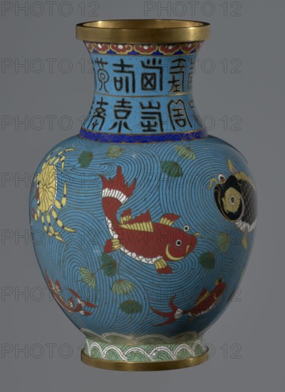 Vase, cloisonné enamel, Qing dynasty 1644–1911, 19th century, China. Vase on a foot with a neck; decoration of fish and crabs on a turquoise background, archaizing inscription on the neck. Height 23.5 cm; diameter 9.3 cm., A rounded vase with a narrow neck and flared gold rim, decorated with a bright blue background covered in swirling wave patterns and accented with green leaf-like shapes, featuring several stylized fish in red, black, and gold with white details, a crab in yellow and gold near one side, bands of decorative motifs in blue, green, white, red, and gold near the neck and base, and a gray backdrop behind the vase.