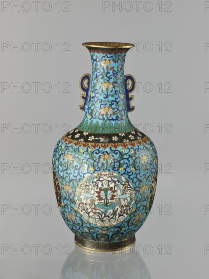 Vase, Chinese, Qing dynasty 1644–1911. Cloisonné enamel. 19th century. Vase with a neck; height 33.0 cm, diameter 15.0 cm, weight 1.7 kg. Decoration: floral and plant tendrils on a turquoise background; birds and animals in circular medallions on a plant background; cranes, deer, peonies, lotuses, chrysanthemums, tigers and other zoomorphic motifs; meander and lotus tendril ornaments. Two stylized handles on the sides of the neck., A single ornate vase with a flared rim and a pair of stylized handles, decorated all over with swirling floral and foliate patterns. The dominant color is bright turquoise blue, with accents of gold, deep blue, green, red, white, black, and touches of brown. The neck and body display repeating scrolling vines and stylized flowers, and there are circular medallions on the body containing symmetrical bird and floral motifs rendered in white, red, green, and gold. The rim and base have metallic gold bands and patterned borders, and small areas of dark blue outl...