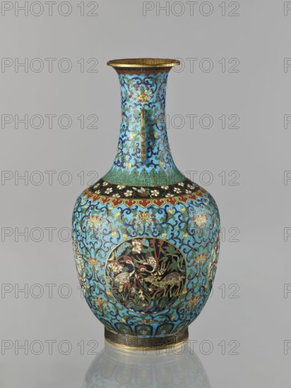 Vase., Chinese, Qing dynasty 1644–1911, 19th century. Cloisonné enamel. Decoration: floral and plant tendrils on a turquoise background; birds and animals cranes, deer, tigers and zoomorphic motifs in circular medallions on a plant background; peonies, lotuses, chrysanthemums; meander and lotus tendril ornaments. Two stylized handles on the sides of the neck. Vessel with a neck. Height 33.0 cm; diameter 15.0 cm; weight 1.7 kg., A tall ornate vase with a flared rim and narrow neck widening into a rounded body, decorated with intricate floral and scroll patterns in bright turquoise, blue, gold, black, red, green, white, and touches of brown, featuring oval medallions with detailed bird and plant scenes on a darker background, a band of stylized motifs near the shoulder and base, and a gold-colored rim and foot.