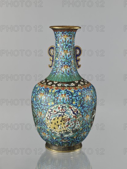 Vase, Chinese, Qing dynasty 1644–1911, 19th century. Cloisonné enamel vessel with a neck, height 33.0 cm, diameter 15.0 cm, weight 1.7 kg. Decoration: floral and plant tendril on a turquoise background; birds and animals lotuses, cranes, deer, tigers in circular medallions on a plant background; peonies, chrysanthemums, zoomorphic motifs, lotus tendril and meander ornaments. Two stylized handles on the sides of the neck., A ceramic vase with a rounded body, narrow neck, and flared rim decorated in intricate floral and foliate patterns in shades of turquoise, blue, green, gold, red, white, black, and yellow, with a pair of symmetrical ornamental handles on the neck in blue and gold, a circular medallion on the body containing a stylized animal motif rendered in yellow and black against a multicolored background, bands of decorative borders near the shoulder and base including metallic gold accents, and a reflective surface that shows the vase standing on a neutral gray background.
