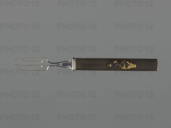 Fork with knife handle kozuka, Japanese, Edo period 1603–1868, 18th century; katana kozuka knife/handle used with swords, fork; cutlery; height 16.9 cm, width 1.4 cm., A metal fork with a long rectangular handle lies horizontally against a gray background, the fork tine section on the left and the handle on the right; the tines and neck are silver and reflective with a smooth polished finish, transitioning to a dark brown handle that has a fine textured surface and a narrow silver collar where it meets the metal; the handle features a small raised decorative motif in golden and darker metallic tones near its mid to right portion.