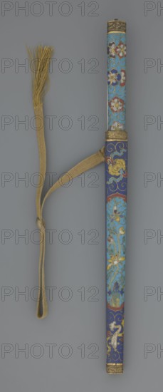 Travel cutlery set in case: 19th-century Chinese Qing cutlery. a Knife with a cloisonné enamel handle; steel blade. b–c Ivory chopsticks, decorated with an inlaid black lacquer ornament at the top in the form of a border. d File decorated similarly to the chopsticks. e Case height 3/4 of the cutlery: cloisonné enamel with bronze fittings engraved with ornamentation at top and bottom; interior lined with wood. Chopsticks and file are held by a band decorated with a matching border. A narrow cotton-silk strap with fringes is attached. Case decorated with flowers in two reserves and plant tendrils in the background. Plant motifs; swastika iconography. Length: 28 cm case., A long cylindrical ornamental case with a decorative strap and tassel, the case covered in blue and turquoise enamel with floral and scrolling motifs in gold, red, white, and dark blue, with gilt metal fittings at both ends; a beige woven strap loops around the case and extends to a beige tassel made of fine threads, and...