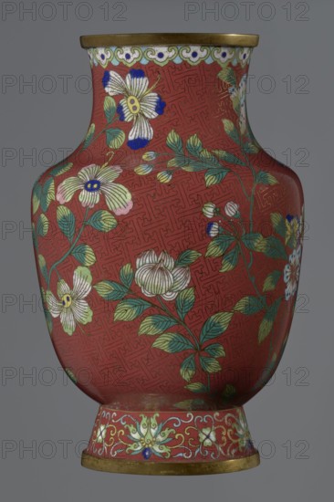 Vase, : Paderewski, Ignacy Jan 1860–1941. Chinese; Qing dynasty Xianfeng period, 1851–1861, 1st half of the 19th century. Cloisonné enamel vessel. The vase is set on a tall, conical foot flaring downwards and terminating in a metal ring, decorated with a lotus tendril. The neck is short and wide, topped with a metal ring, below which is a border composed of ruyi-heads. The belly and neck are decorated all around with a composition of flowers and plum branches against a red Chinese meander background. Height 25.1 cm; diameter 16.5 cm; weight 1.5 kg., A rounded vase with a narrow neck and flared rim decorated with floral motifs on a red background; the surface shows a repeating geometric pattern in a slightly darker red, and branches with green leaves and blossoms in white, pale yellow, pink, and blue spread across the body; the rim and foot have gold-colored bands, and the foot area features an ornate floral border in pale green, white, yellow, and blue against the red; overall colors v...