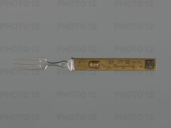 Fork with knife handle kozuka, Japanese, Edo period 1603–1868, 18th century, kozuka form for katana, fork, materials/katana fitting/weapon accessory, melee weapon/sword accessory, subject: flies motif, cutlery, height 16.9 cm, width 1.7 cm, A metal fork with a silver-toned three-pronged head and a narrow neck attached to a rectangular golden handle; the handle has a raised small sculpted fish motif and several incised decorative marks, with a darker rectangular panel near one end; the background is a uniform muted gray.