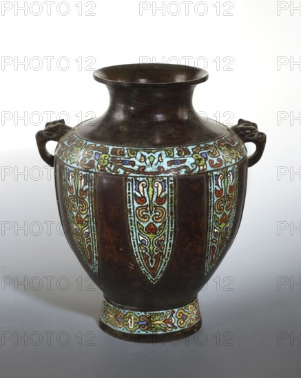 Vase with two handles, Chinese, Qing dynasty 1644–1911, 19th century. Cloisonné and champlevé enamel vessel decorated with cicadas and dragons. Height 31 cm; diameter 23.8 cm., A rounded vase with a wide flared neck and a narrow foot sits against a light background, its surface predominantly dark brown with areas of worn sheen. A decorative band near the shoulder and another around the foot feature ornate enamel patterns in turquoise, pale green, red, blue, and gold, forming repeating vertical panels that extend down the body. The vase has a pair of short handles on opposite sides shaped like stylized animal heads in the same dark brown material. The overall appearance combines the deep brown base color with bright accents of turquoise, pale green, red, blue, and gold in intricate curving designs.