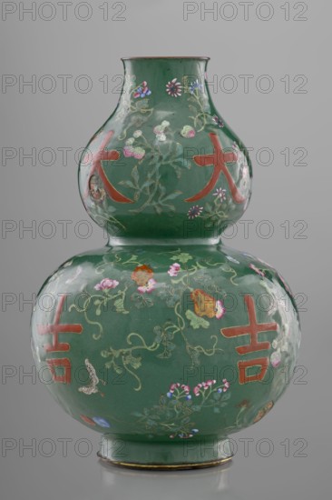 Vase, Chinese, Qing dynasty 1644–1911, 18th century. Calabash-shaped vessel, height 34.3 cm, diameter 24.0 cm. Decoration on a green background with flowers, butterflies, fruit peaches, lingzhi, peonies, and floral ornament; pictographic signs among the plant motifs., A double-gourd shaped ceramic vase with a glossy deep green surface decorated with painted floral vines, blossoms, and small butterflies in colors including pink, purple, blue, gold, and white, with large bold reddish-orange motifs on both bulbous sections; the vase has a narrow flared neck rim with a thin darker edge and sits on a slightly raised base with a subtle metallic band, all set against a plain neutral gray background.