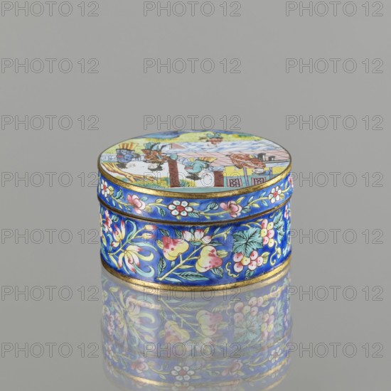 Box with a lid; creator, painted enamel; Qing dynasty 1644–1911; 19th century; Chinese and Vietnamese Southeast Asian influences; Nguyen dynasty 1802–1945 associations; decorative figurative scenes of peonies, grapes, and peaches iconography; container; height 3.3 cm, diameter 6.3 cm., A small round trinket box sits on a reflective surface, the lid and sides covered in detailed painted scenes and floral patterns. The box shows a vibrant palette of blue, pink, yellow, green, white, and gold. The lid features a multicolored scene with human figures and architectural elements painted in muted tones, while the sides display ornate floral vines with blossoms and leaves on a rich blue background accented by gold bands. The reflection on the surface beneath the box mirrors the colors and patterns.