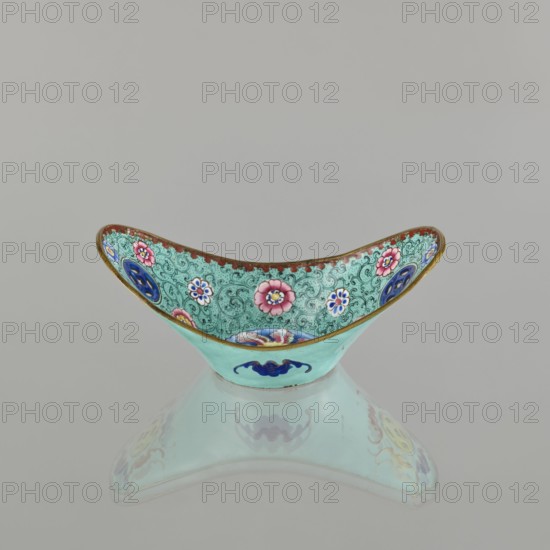 Bowl, painted enamel on vessel, Qing dynasty 1644–1911, 18th–19th century China. Decoration: boats, bats iconography, lotuses, coins, floral tendril; symbols of happiness. Dimensions: height 6.3 cm, width 8.5 cm, depth 15.3 cm., An ornate shallow bowl with a curved rim decorated on the inside with floral motifs in pink, blue, white, and green against a turquoise background with intricate dark green swirls and a gold-trimmed edge, the exterior showing a pale turquoise surface with a blue decorative emblem, all reflected faintly beneath the bowl; visible colors include turquoise, green, pink, blue, white, gold, and red.