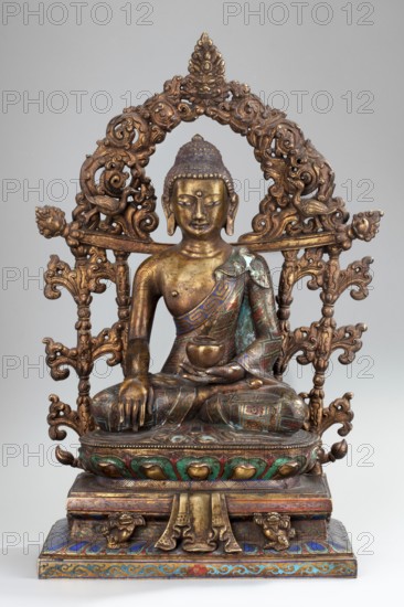 Shakyamuni Buddha, unknown sculptor; 18th century, China; Sino-Tibetan style Tibetan Buddhist sculpture depicting Buddha iconography ushnisha, bowls, vajras, lotus throne; materials: sculpture; dimensions: height 38.0 cm, width 25.0 cm, depth 13.7 cm; cultural attribution: Chinese, Himalayan/Tibetan Buddhist art., A gilded metal seated figure on a decorated pedestal, framed by an ornate openwork arch with scrolling floral and foliate motifs; the figure wears a patterned draped garment showing turquoise, blue, green, red, and gold tones, and holds a small bowl in one hand while the other hand rests on the knee; the skin of the figure appears in gold and bronze hues with areas of patina; the arch and base are predominantly gold with accents of green, blue, red, and turquoise, and the base features carved ornamental elements and stylized blossoms.
