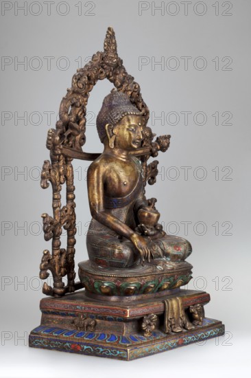 Shakyamuni Buddha, gift; Chinese, Tibetan/Sino-Tibetan style; Tibetan Buddhist art, Himalayan art; 18th century, China; sculpture of Shakyamuni Buddha with ushnisha, vajras, bowls, lotus throne; height 38.0 cm, width 25.0 cm, depth 13.7 cm., A seated statue of a figure with a textured headpiece and elongated earlobes, positioned on a decorated pedestal and framed by an ornate arch; the figure holds a small vessel and has one hand resting on a knee while sitting cross-legged. The surface shows metallic tones of gold and bronze, with accents of green, blue, red, and purple on the pedestal and garments. The arch and base feature intricate carved floral and scrollwork designs in darker bronze hues, and the overall background is a smooth light gray.