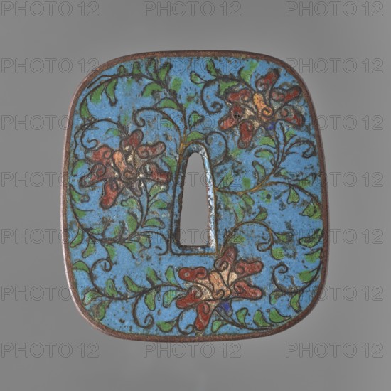 Crossguard tsuba, Japanese, Edo period 17th century, 1603–1868. Rectangular tsuba with rounded sides nadegaku gata, decorated on both sides with a karakusa floral tendril motif on a blue background, made with the cloisonné enamel technique and stylized after Chinese enamel wares. Unsigned. Tsuba sword crossguard, height 7.4 cm, width 6.8 cm, depth 0.5 cm., A square metal object with rounded corners and a central tapered rectangular hole is shown against a gray background; the front surface is covered in a bright blue enamel with decorative floral motifs in red and orange, green leaves, and dark brown or black outlining, and the metal edges show a brownish patina.