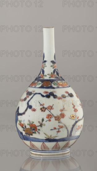 Bottle, porcelain with bamboo, pine, and plum decorations Three Friends of Winter, Imari-style sake bottle, ca. 1700–1730, Arita, Japan; height 22.3 cm, diameter 12.2 cm., A porcelain bottle-shaped vase with a long narrow neck and bulbous body, predominantly white with visible crackle in the glaze, decorated with blue, orange, red, green, gold, and brown painted floral and branch motifs, including stylized blossoms and leaves around the shoulder and body, a band of blue near the base and a patterned border of leaf-like shapes in red above the foot, and additional blue brushwork forming branches and accents around the surface against a neutral gray background.