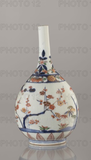Bottle, porcelain, Arita, Japan, ca. 1700–1730; height 22.3 cm, diameter 12.2 cm. Decoration: Imari palette with bamboos, pines, plums Three Friends of Winter, sake motif; subject and plant ornament; Japanese ceramics., A rounded porcelain bottle with a long narrow neck sits against a neutral gray background; the bottle is primarily white with visible fine crackle in the glaze and decorated with hand-painted floral and botanical motifs in blue, orange, green, gold, and red; the shoulder and neck feature stylized floral bands in deep blue and orange with green leaves, while the body shows branches with blossoms in orange and red, leaves in green and gold highlights, and a blue horizontal band near the base; the foot has repeated leaf-like patterns in red and thin blue decorative bands.