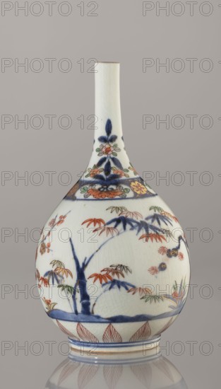 Bottle, porcelain with painted bamboos, pines, plums and sake motif Three Friends of Winter, Imari style, ca. 1700–1730, Arita, Japan; height 22.3 cm, diameter 12.2 cm., An off-white ceramic vase with a long narrow neck and a rounded body decorated with hand-painted floral and botanical motifs in blue, red-orange, green, and yellow, featuring stylized leaves and branches, a band of floral ornament near the neck, and a pattern of pointed leaf shapes near the base; the surface shows fine crackle in the glaze and the background appears a pale gray-beige.