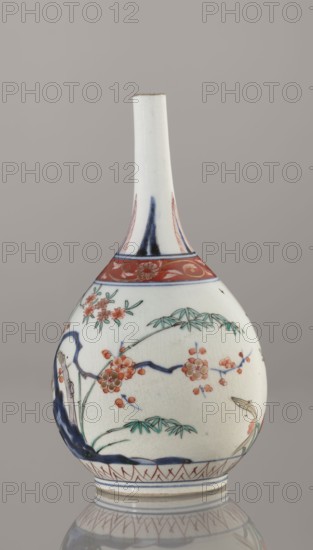 Bottle, Japanese, Edo 1603–1868, early 18th century. Porcelain vessel sake bottle, height 22.1 cm, diameter 12 cm. Decorated in the kakiemon style with a motif of the three friends of winter bamboo, plum, and pine, with a rock, plus two borders with plant motifs and floral patterns on the neck., A white ceramic bottle-shaped vessel with a long narrow neck and rounded body sits against a neutral gray background, decorated with painted floral branches and leaves in colors including blue, green, red, orange, and a touch of black; the upper neck area has blue and red decorative bands, and the body shows stylized blossoms and bamboo-like foliage with flowing blue brushstrokes and red-orange flowers, with a patterned red border near the base and a reflected image of the vessel visible on the surface beneath it.