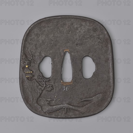 Crossguard tsuba, Kaneie craftsman, Japanese, Edo period 18th century. Tsuba in the shape of a rectangle with rounded corners nadegaku gata, slightly convex edge uchi kaeshi, with ryôhitsu ana of identical three-petal shape. Decorated in relief: obverse with ten figures of Buddhist and Taoist saints; reverse with a landscape featuring a pavilion and a bridge over an embankment. Details inlaid with gold, shakudo, and brass. Materials/subject: metal sword crossguard tsuba; motifs include pagodas, pine trees, bridges, trees, and rocks. Place of origin: Yamashiro province, Fushimi, Japan. Dimensions: height 8.4 cm; width 7.6 cm; depth 0.4 cm., A square-edged, rounded object with a rough dark brown to black metallic surface resting against a light gray background, showing three irregular cutouts near its center and a carved low-relief design on one side depicting organic, flowing shapes and a partial tree or branch motif with a few small gold-colored inlays; the edges are slightly raised an...