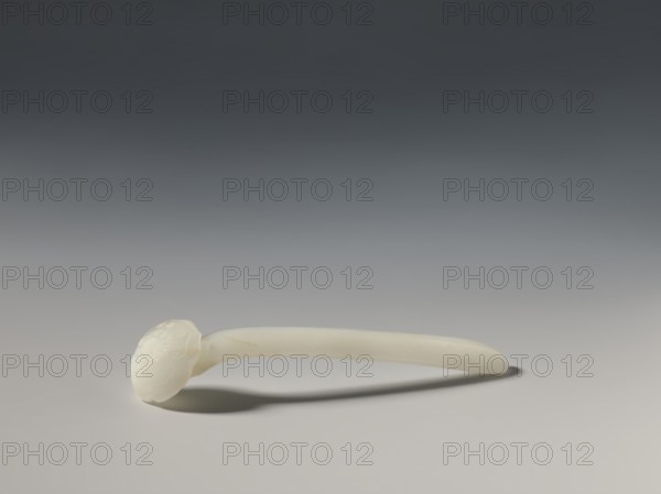 Hairpin, Chinese, Chinese art, toiletries, ruyi auspicious scepter iconography, Qing 1644–1911, milky white jade, fully carved head, relief decoration, 18th–19th century, China, height 1.9 cm, width 2.7 cm, depth 10.4 cm., A smooth, pale off-white object resembling a long curved handle with a rounded decorative end rests on a neutral surface, casting a soft shadow; the background transitions from light gray near the surface to darker gray toward the top, and the object shows subtle variations of cream and very light beige.