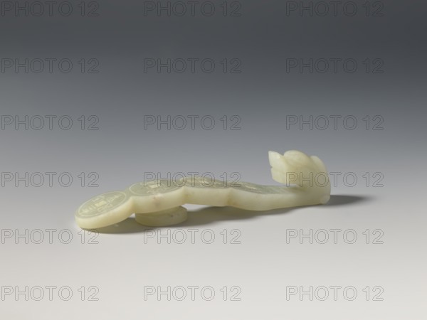 Belt clasp, purchase; Chinese, Chinese art; coins, dragons iconography; Qing 1644-1911; Shaft: four connected Chinese coins. Milky-white jadeite with a slightly green tint. Full-plastic carved head, engraved. Early 20th century, China. Belt buckle; height 2.4 cm, width 11.3 cm, depth 2.3 cm., A pale, smooth carved object rests on a flat surface with a gradient gray background; the object is an off-white to creamy color with subtle darker flecks and a glossy finish, featuring a rounded, segmented form that tapers to a carved end resembling a floral or bud-like shape, and it casts a soft shadow to the right.