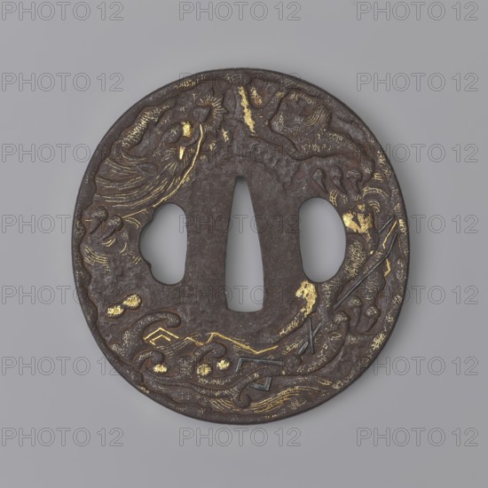 Crossguard tsuba, Masashige. Round tsuba maru gata with a slightly raised, irregularly outlined edge highlighted by a delicate gold nunome inlay. Decorated on the obverse with a tiger, bamboos and pine, on the reverse with a dragon among sea waves and lightning; details of the decoration inlaid with gold and shakudo patinated copper. Signed. 1806 Edo period, Bunka 3, 8th month. Japan, Echizen. Tsuba; height 7.5 cm, width 7.8 cm, thickness 0.55 cm., A round metal object with a dark brown surface and irregular gold highlights, featuring a central vertical slit flanked by two rounded openings; the outer edge is decorated with carved flowing patterns that suggest waves and organic shapes, with textured raised areas and scattered gold inlay, all set against a smooth light gray background.