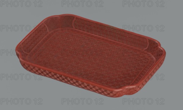 Tray, Chinese, Qing dynasty 1644–1911, 18th–19th century. Porcelain vessel, height 2.0 cm, width 17.6 cm, depth 12.8 cm. Decoration: leiwen ornament, meander ornament, swastika iconography, kikko pattern, geometric ornament., A rectangular tray with raised sides and rounded corners sits against a plain background, showing a textured surface and patterned interior and exterior surfaces; the tray appears primarily red with variations in tone, and the background is gray.