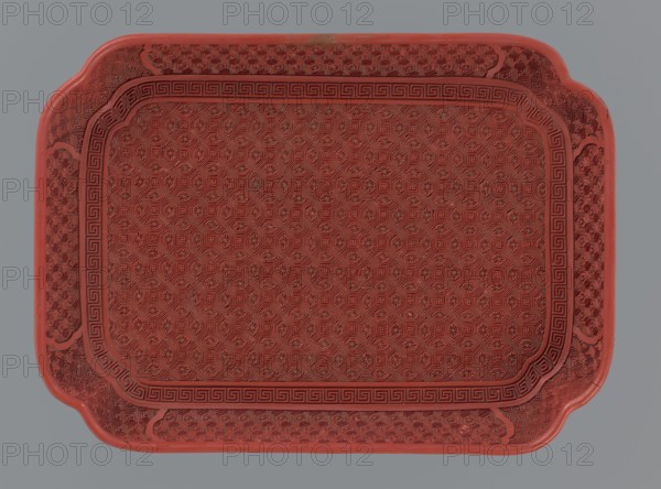 Tray, gift, Chinese art, Chinese, Qing 1644–1911, leiwen ornament, meander ornament, swastika iconography, kikko pattern, geometric ornament, 18th–19th century, China, vessel; height 2.0 cm, width 17.6 cm, depth 12.8 cm, A rectangular tray with rounded corners and scalloped edges, predominantly red with subtle darker red detailing, featuring an all-over repeating geometric and floral embossed pattern across its surface, a bordered inner panel with a Greek key style motif, and a background that is a flat muted gray.
