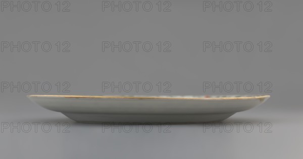 Plate. Porcelain fragment; white glaze. Decoration painted with overglaze enamel paints and iron red, featuring plant motifs and figural scenes. Colored porcelain, Qing dynasty 1644–1911, 18th century, China. Height 2.4 cm; diameter 20.4 cm; weight 0.35 kg., A shallow round plate shown in profile with a smooth, slightly curved rim highlighted by a thin gold edge, the plate surface appearing white with subtle off-white and pale gray shading, resting on a low foot against a uniform gray background; there are hints of muted green and red near the rim.